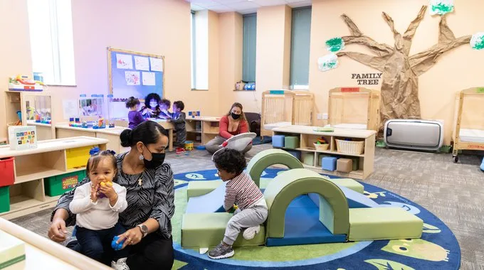 The child care program at Dorcas International includes child-sized furnishings in natural wood tones, ample space for activity areas and large windows for natural light.